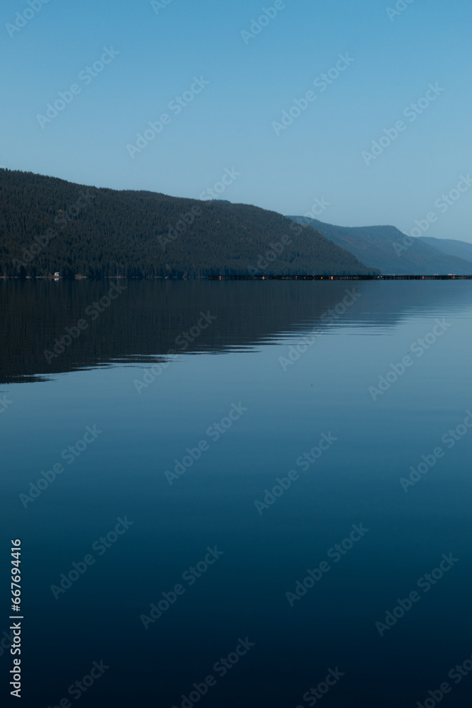 Beautiful view of a mountain and calm water with smooth surface. Beautiful view of a mountain and calm water with smooth surface.