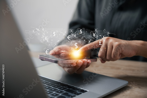 Currency exchange and interbank payment concept, woman using mobile phone and laptop computer to transfer money, global business, FinTech, financial technology, online banking.