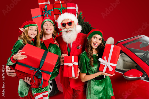 Funny four people costume theme x-mas party preparation concept hold presents isolated white color background