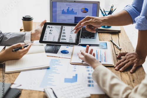 Business people discuss marketing growth chart and make business plan. Business meeting, financial consultants brainstorm analysis of statistical charts in financial reporting documents.