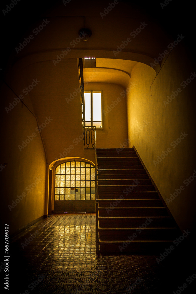 dimly lit stairwell and window dimly lit stairwell and window