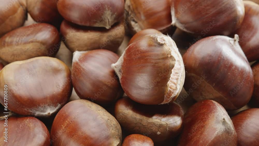 Edible sweet chestnuts move slowly in the frame. Nice food background for your projects. Edible sweet chestnuts move slowly in the frame. Nice food background for your projects.