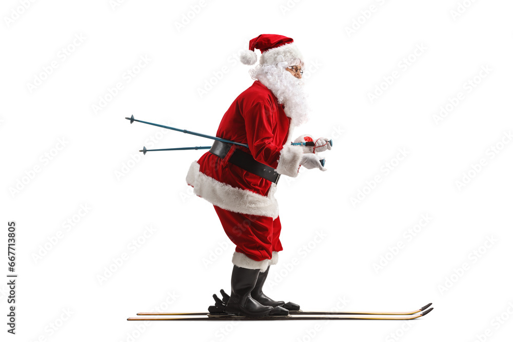 Full length profile shot of Santa Claus skiing Full length profile shot of Santa Claus skiing