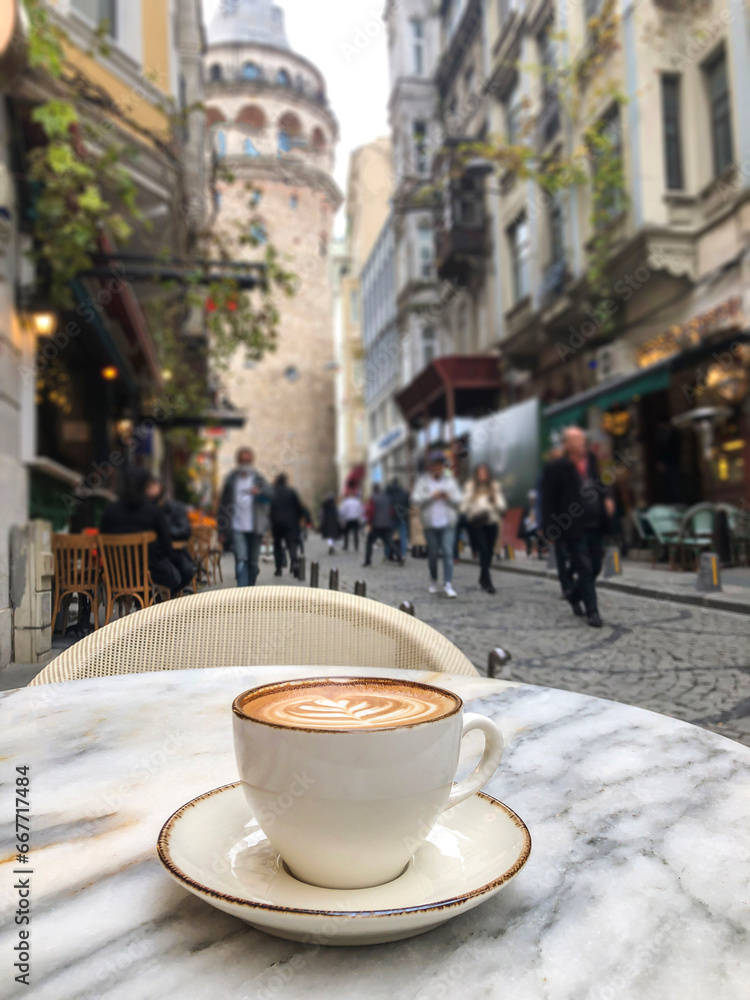 cup of coffee over Galata tower in Istanbul, Turkey