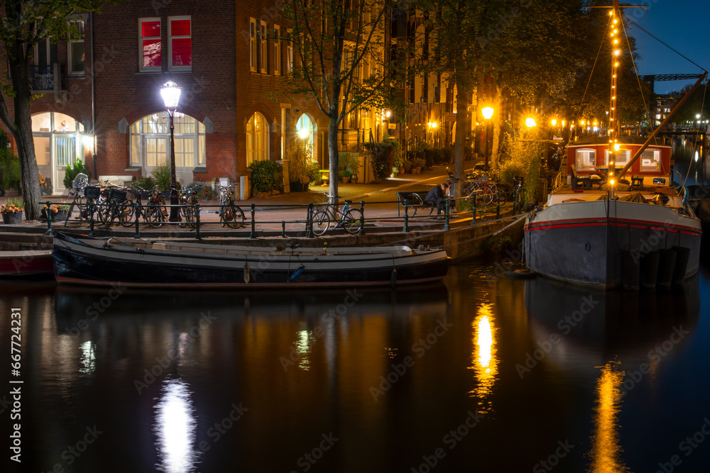 Night Amsterdam Quay with Bicycles and Houseboats