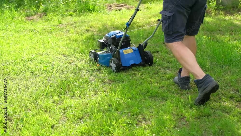 Lawn mower cutting grass. Small grass cuttings fly out of lawnmower. Grass clippings get spewed out of a mower pushed around by landscaper. CloseUp. Gardener working with mower machine. Mowing lawn
Lawn mower cutting grass. Small grass cuttings fly out of lawnmower. Grass clippings get spewed out of a mower pushed around by landscaper. CloseUp. Gardener working with mower machine. Mowing lawn