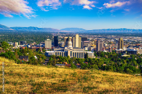 Salt Lake City skyline with Utah State Capitol. The capitol is the main building of the Utah State Capitol Complex, which is located on Capitol Hill. photo
