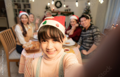 Happy family taking selfie photo with mobile phone at Christmas dinner party