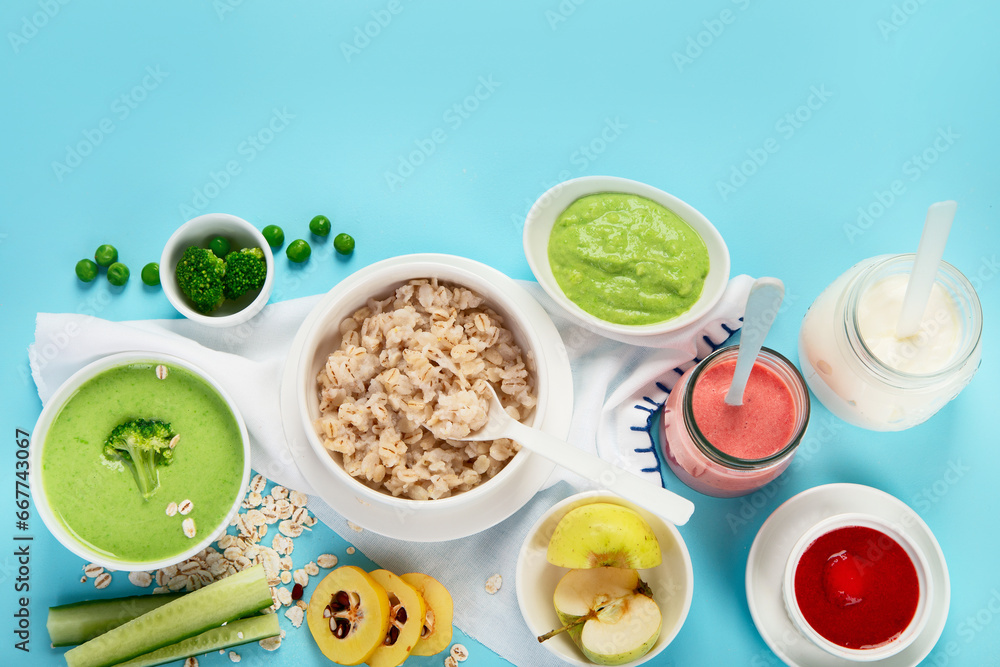 Bowls with healthy baby food on blue background. Bowls with healthy baby food on blue background.