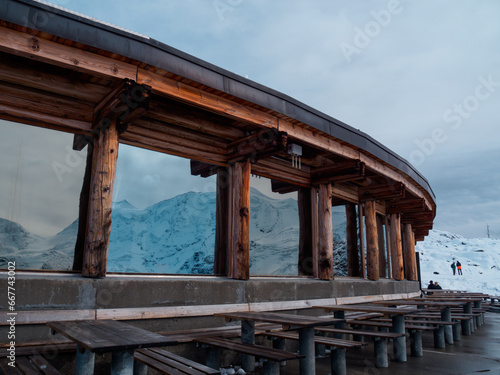 Part of restaurant with a panoramic terrace at the top station of Diavolezza. The building was decorated by wood and glass.
