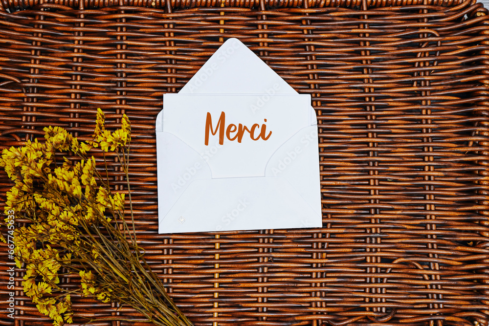 Merci french word mean thank you in english card in an envelope with