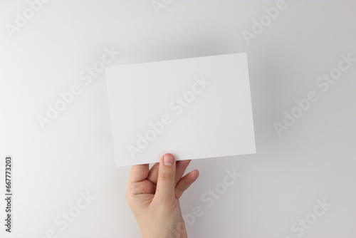 Card mockup in minimalist style, blank card in hand