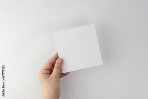 Square Card mockup in minimalist style, blank card in hand