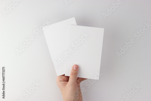 Card mockup in minimalist style, two blank cards in hand photo