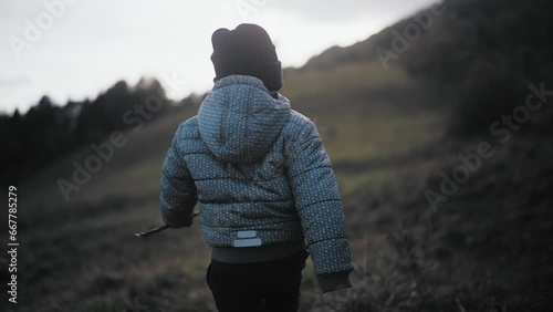 Child walking in a valley