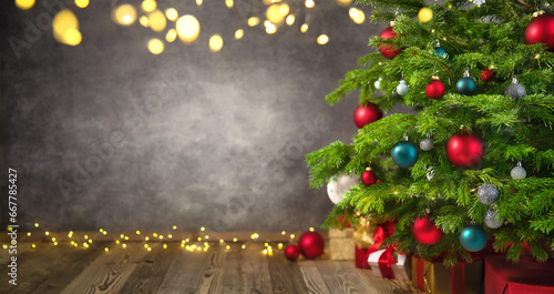 Delightful Christmas tree closeup with textured gray wall as a nice background framed with lights and vignetting photo