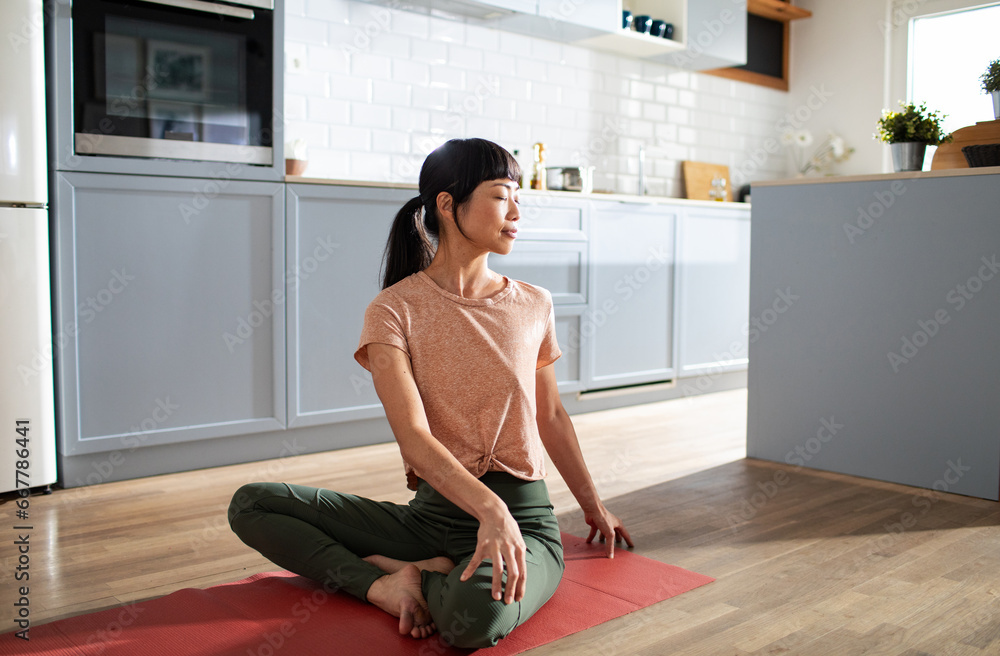 Young woman practicing yoga and mediating in the living room Young woman practicing yoga and mediating in the living room