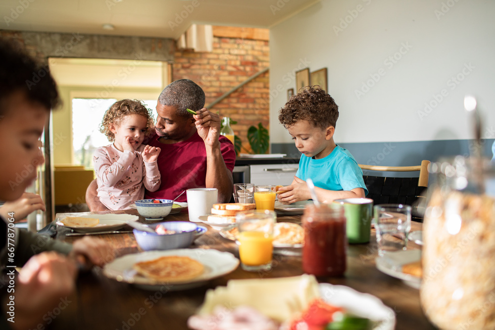 Father and Children Share Breakfast Together Father and Children Share Breakfast Together