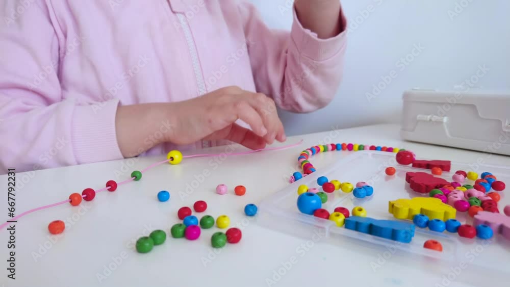 Process of making a bracelet from a thread and colored beads, concept of hobby Process of making a bracelet from a thread and colored beads, concept of hobby