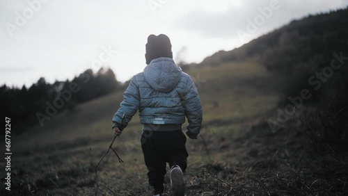 Child walking in a valley