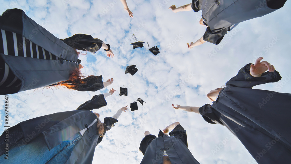 Graduating students hands throwing graduation caps in the air. Stock ...