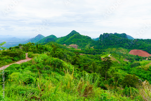 Complex mountain views and fresh green forests And there is a small, rough, winding road in Loei Province, Thailand.