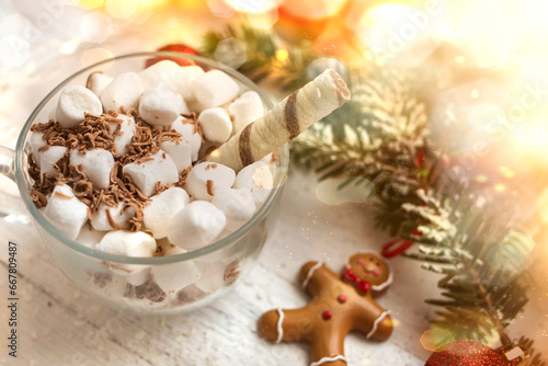 Christmas background. Cup of hot chocolate with marshmallows on a white wooden background.