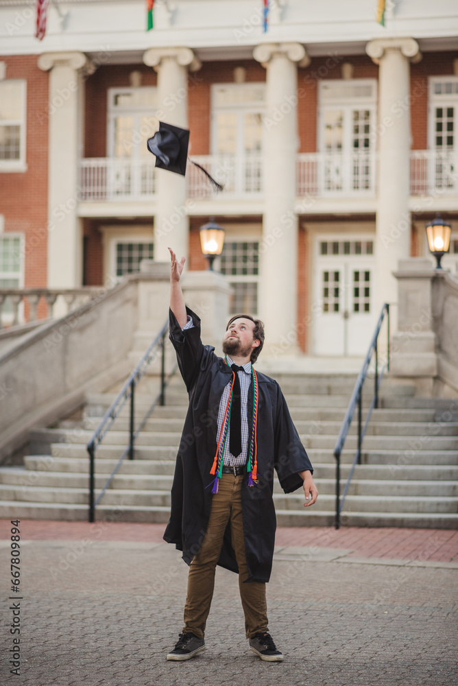 White male college grad on a brick campus