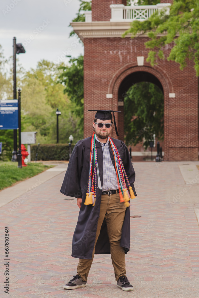 Fototapeta premium White male college grad on a brick campus