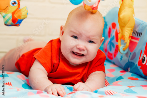 Portrait of cute baby a newborn girl playing in the room