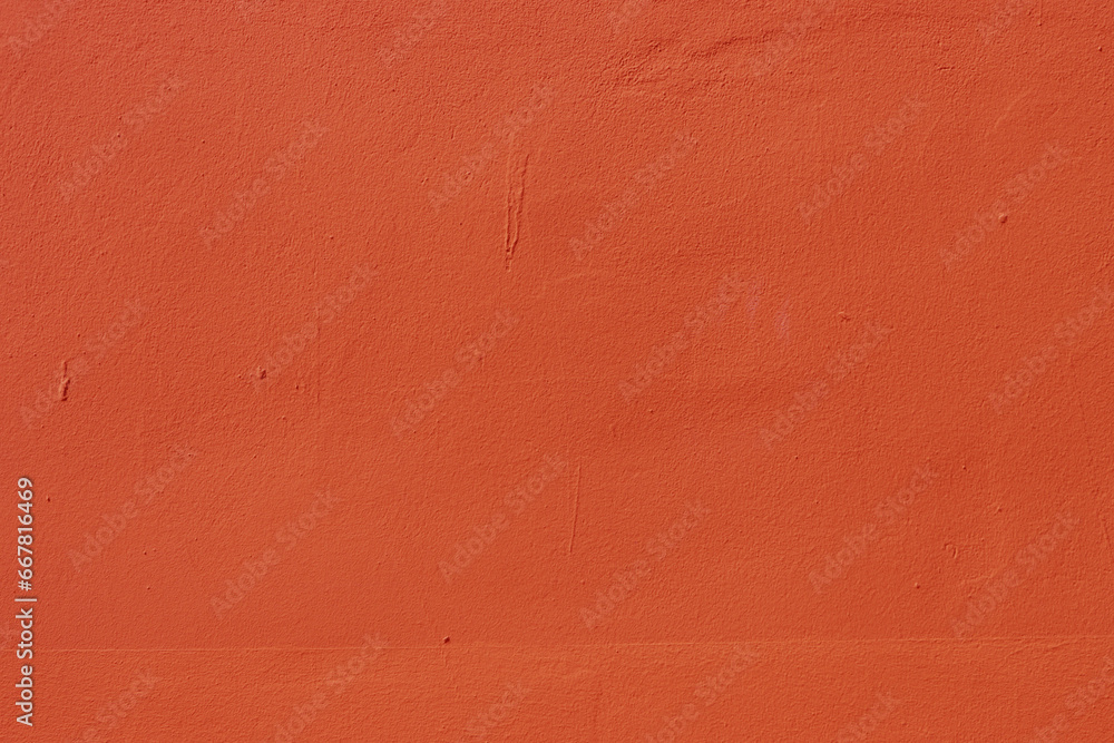 Fototapeta premium The surface of an old wall with red plaster.