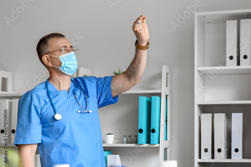 Mature male doctor in medic...