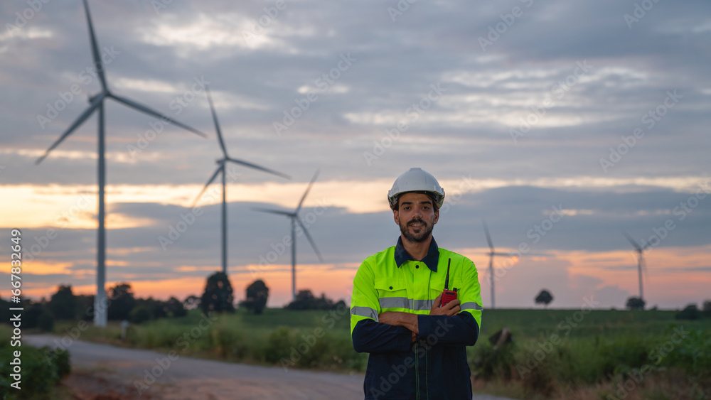 Service engineers checking system of windmill with tablet. Wind turbines generate electricity. Clean and Renewable energy concept. Service engineers checking system of windmill with tablet. Wind turbines generate electricity. Clean and Renewable energy concept.