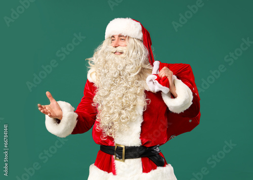 Portrait of Santa Claus with bag of gifts on green background