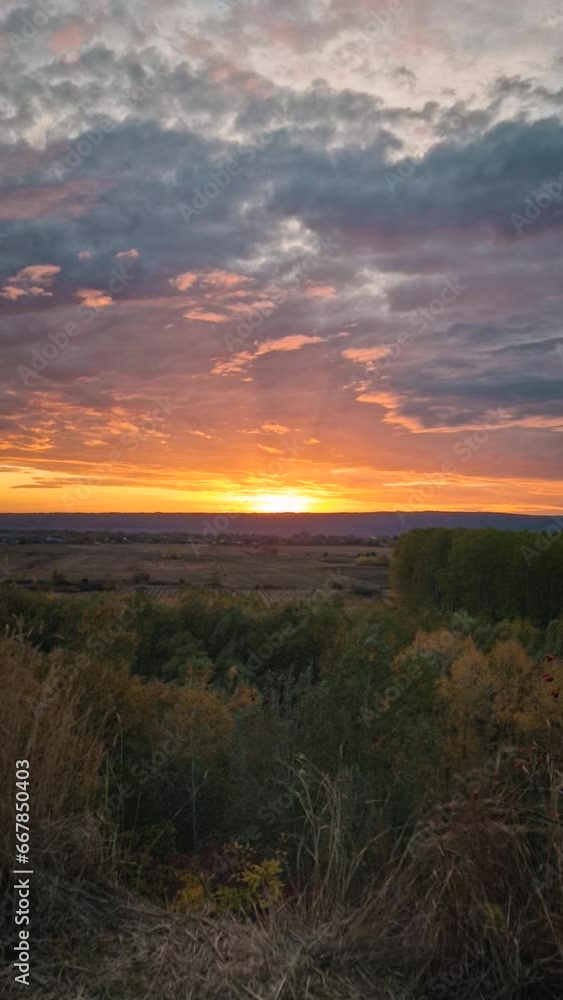 Autumn evening over the valley. Beautiful view to the multicolored forest and orange october sunset. Picturesque fall season scenery Autumn evening over the valley. Beautiful view to the multicolored forest and orange october sunset. Picturesque fall season scenery