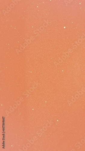 Sand beige tiny dots glitter on orange coral gradient background that form an abstract figure with itself. Vertical stars backdrop party or Christmas holidays and New Year concept with copy space