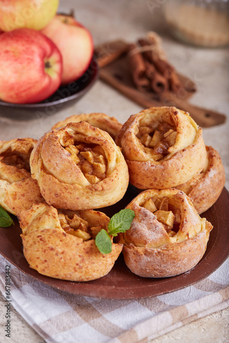Rose shaped mini open pies with apples, cinnamon and brown sugar. Delicious homemade sweet buns.