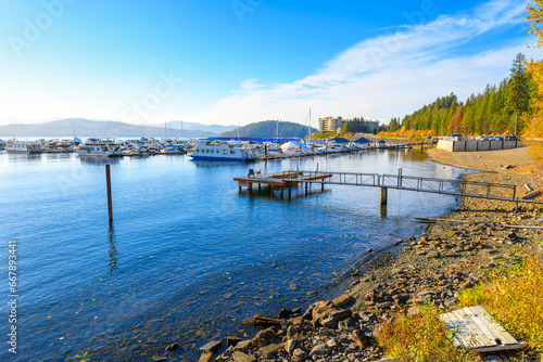 The Silver Beach marina with Tubbs Hill and upscale condominiums in view behind with fall colors on the trees at Lake Coeur d'Alene, Idaho. © Kirk Fisher
