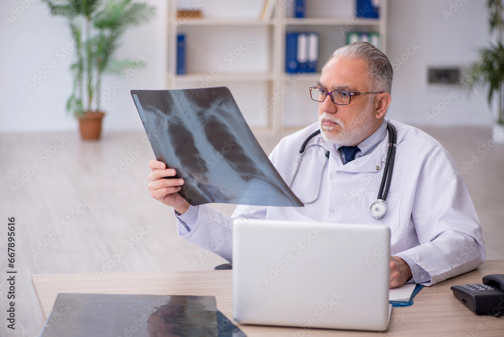 Old male doctor radiologist working in the clinic Old male doctor radiologist working in the clinic