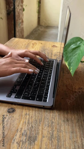 Woman writing notes on her laptop vertical social media concept