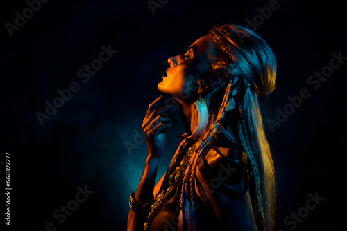 Photo of dreamy mystic woman wear gothic valkyrie doing sacrificial ritual isolated dark orange color background