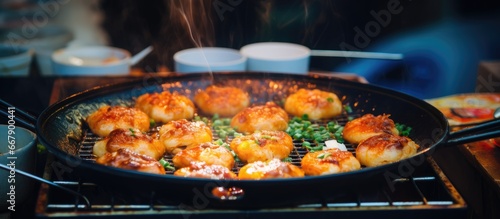 Octopus balls known as takoyaki are sold at the night market in Huahin Thailand as a popular Japanese street food