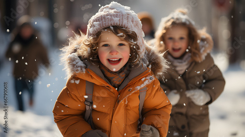 Two little girls having fun in the snow on a sunny winter day.