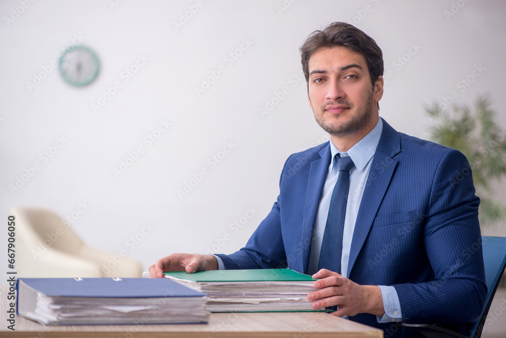 Young male employee working in the office Young male employee working in the office
