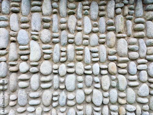 rock wall of natural river stones photo