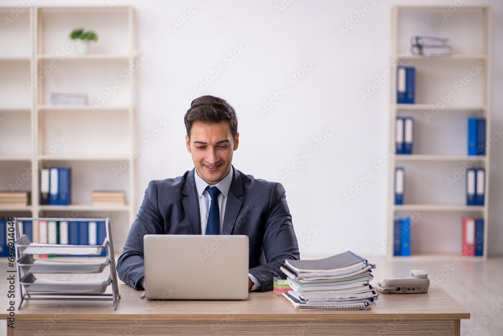 Young male employee working in the office Young male employee working in the office