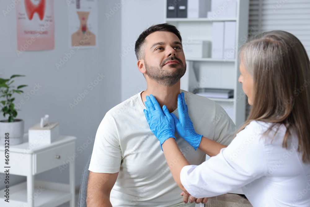 Endocrinologist examining thyroid gland of patient at hospital Endocrinologist examining thyroid gland of patient at hospital
