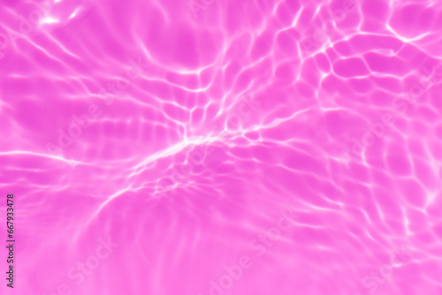 Purple water bubbles with ripples on the surface. Transparent pink colored clear calm water surface texture with splashes and bubbles. Water waves with shining pattern texture background.