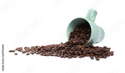 Coffee beans and overturned cup isolated on white