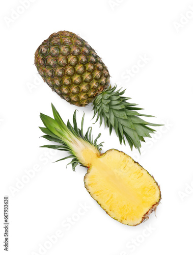 Whole and cut ripe pineapples on white background, flat lay. Space for text